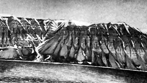 Отвесные горы причудливой формы обрамляют фьорд.