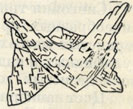 Рис. 221. Кристалл доломита с седлообразно изогнутыми гранями